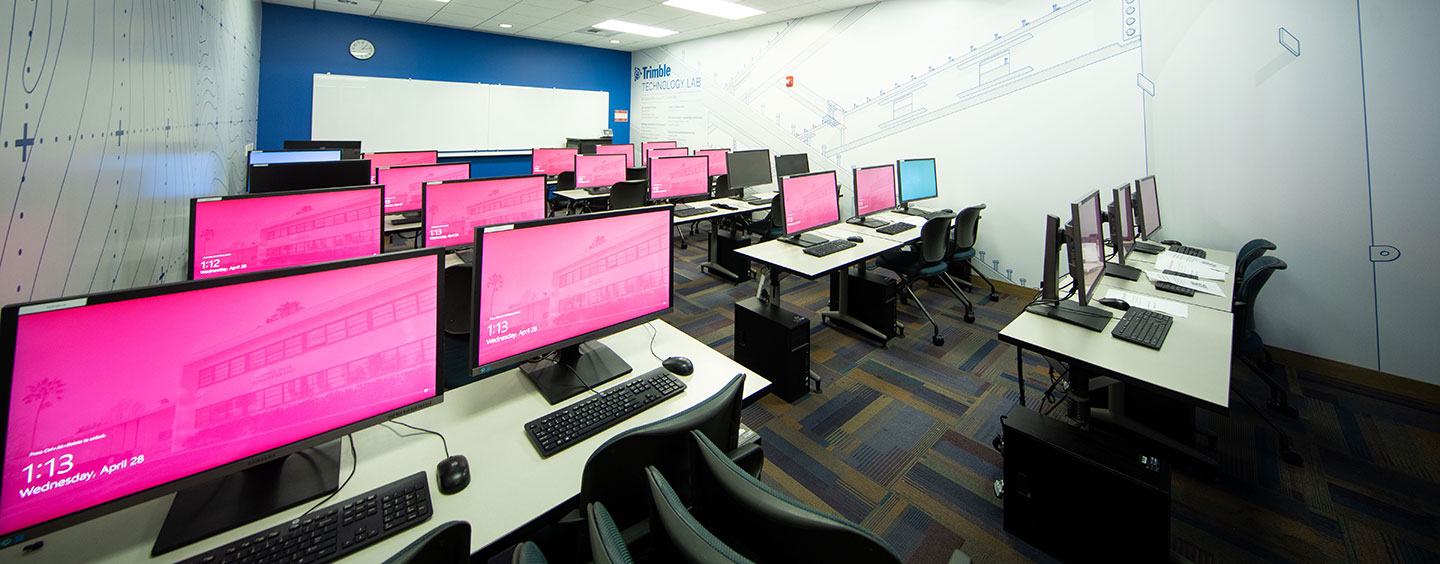Many desktop computers set to their welcome screens in a technology classroom